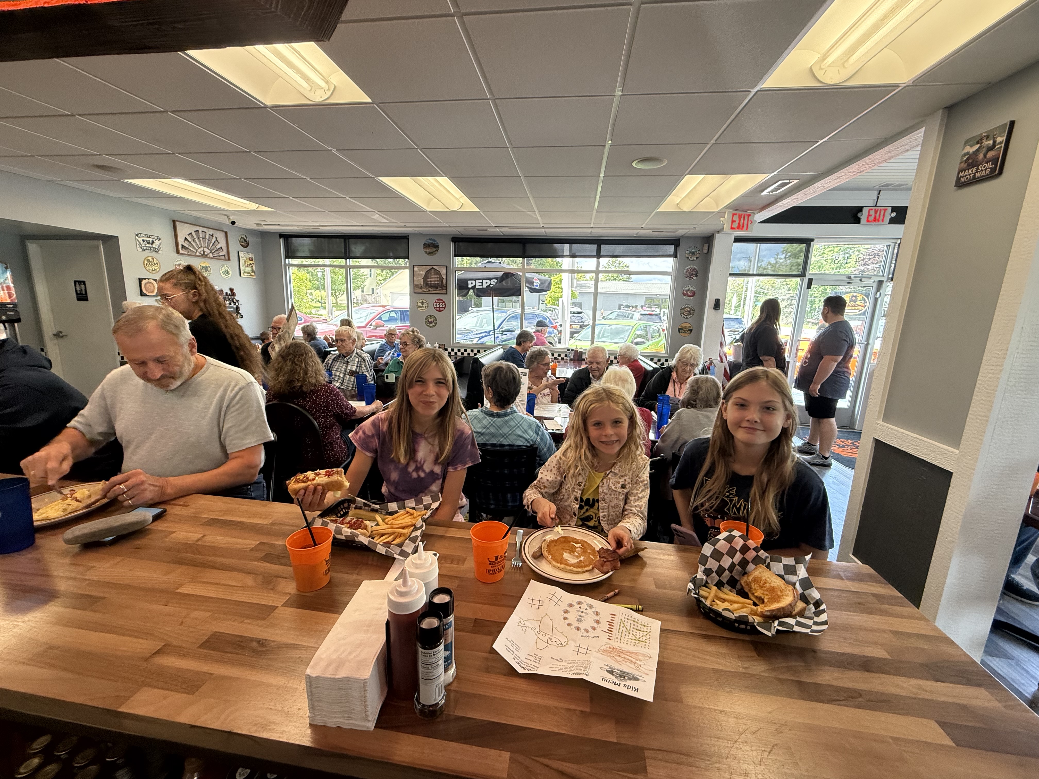 Families enjoying meals inside J&S Kingsley diner
