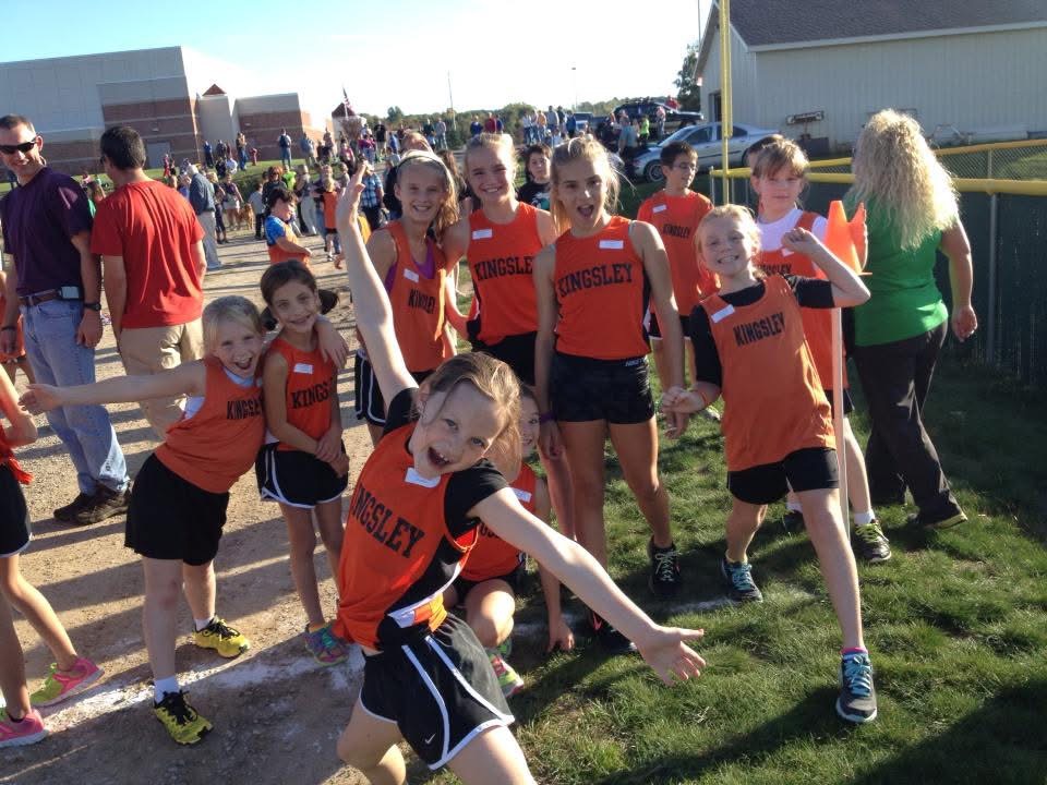 Kingsley youth cross country team in orange jerseys